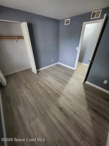 an empty room with wooden floor