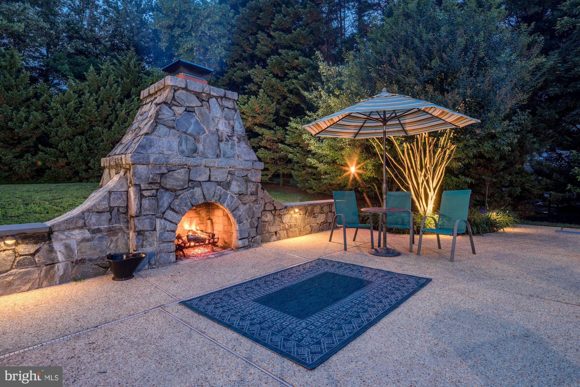6 Beall Spring Court Potomac, MD 20854 - Photo 42 of 54 Night view of Fireplace w/ Patio Area