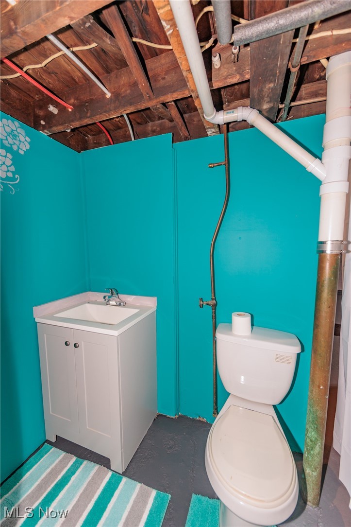 3181 Warren Road Cleveland, OH 44111 - Photo 23 of 28 Bathroom featuring concrete flooring, vanity, and toilet