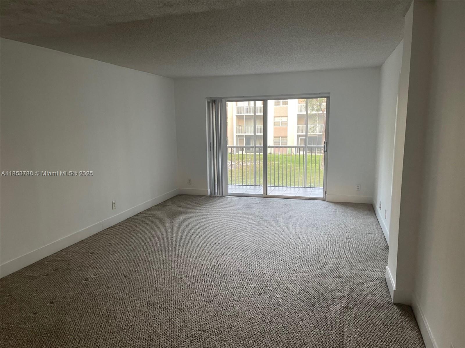 1075 Riverside Drive, Unit 203 Coral Springs, FL 33071 - Photo 5 of 9 a view of an empty room with a window