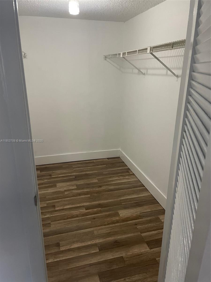 1075 Riverside Drive, Unit 203 Coral Springs, FL 33071 - Photo 6 of 9 a view of a room with racks on the wall