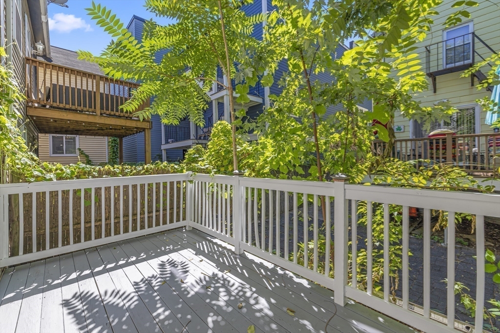 45 Ward Street Boston, MA 02127 - Photo 14 of 16 a balcony with wooden floor in front of it