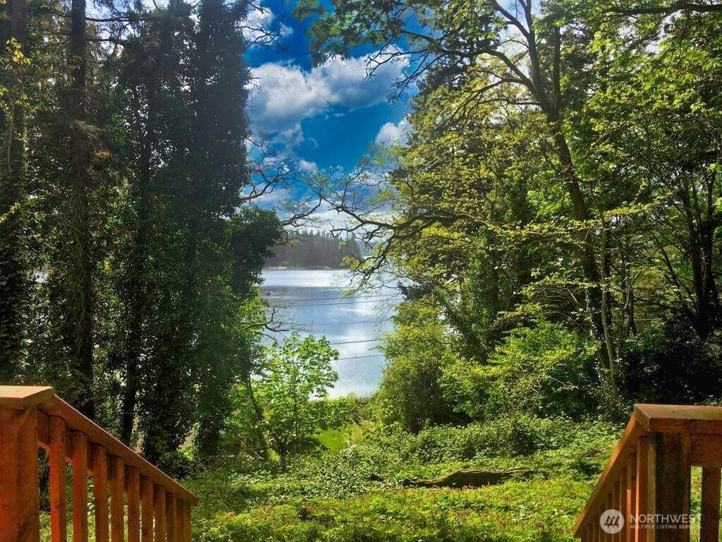 6810 Northeast Bergman Road Bainbridge Island, WA 98110 - Photo 15 of 24 a backyard of a house with lots of green space and lake view