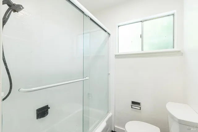 a bathroom with a shower a toilet and a sink