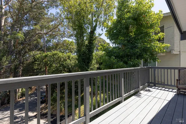 a balcony with wooden floor and fence