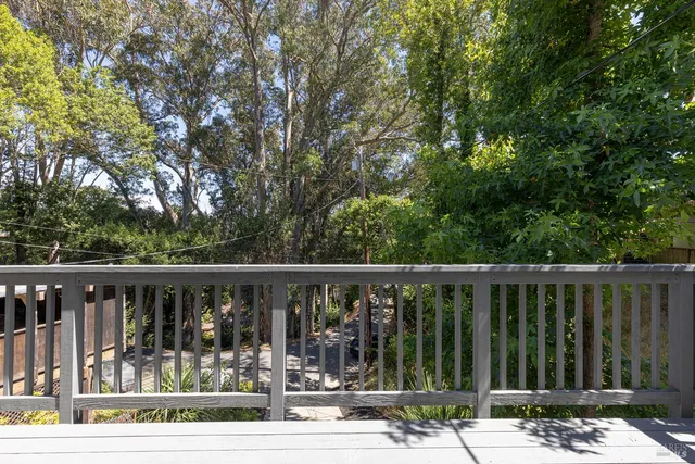a view of a balcony with wooden floor
