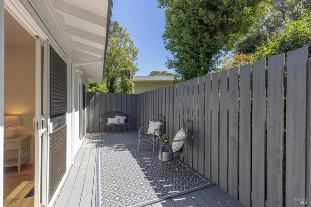 a view of a chair and tables in the balcony