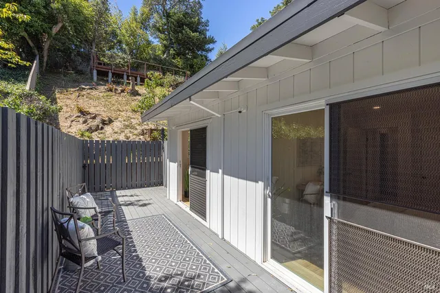 a view of a house with a bench in patio
