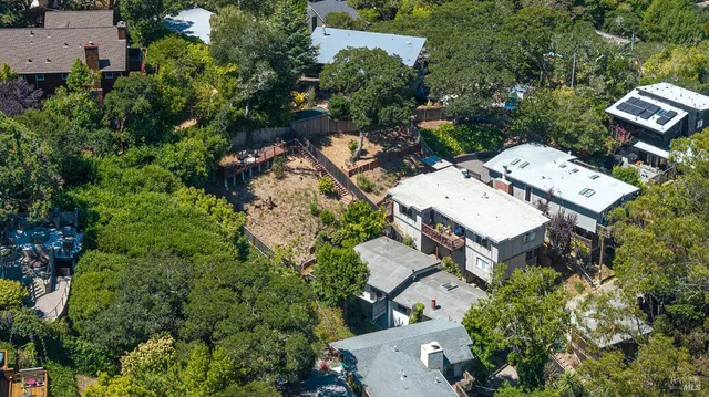 an aerial view of a house with yard and outdoor seating