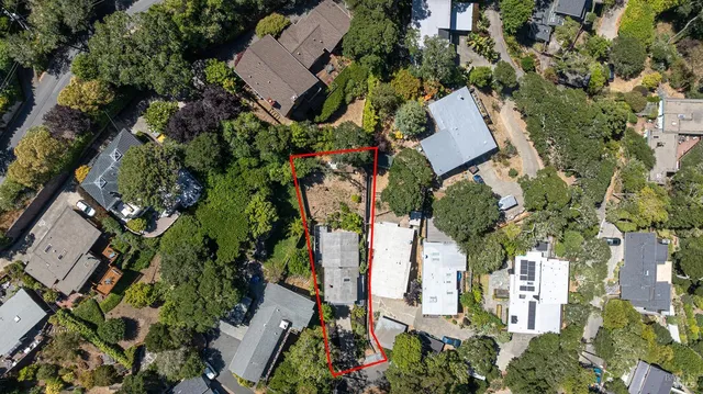 an aerial view of a house with a yard and garden