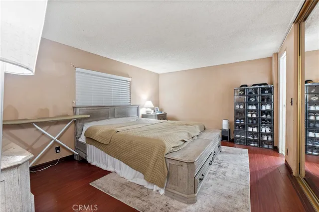 a bedroom with a bed and a wooden floor