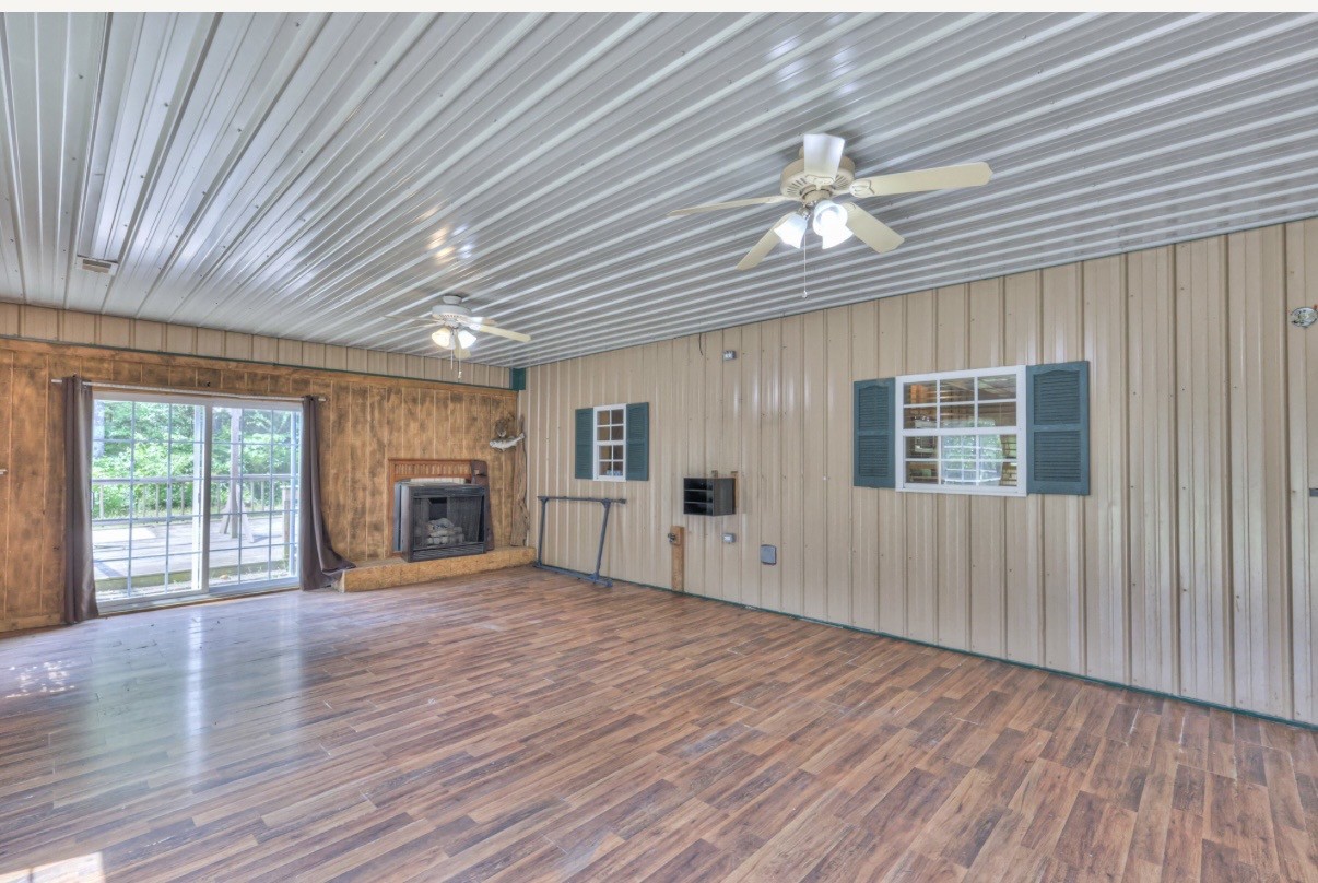 417 Haskins Chapel Road Lewisburg, TN 37091 - Photo 11 of 27 an empty room with wooden floor fireplace and windows