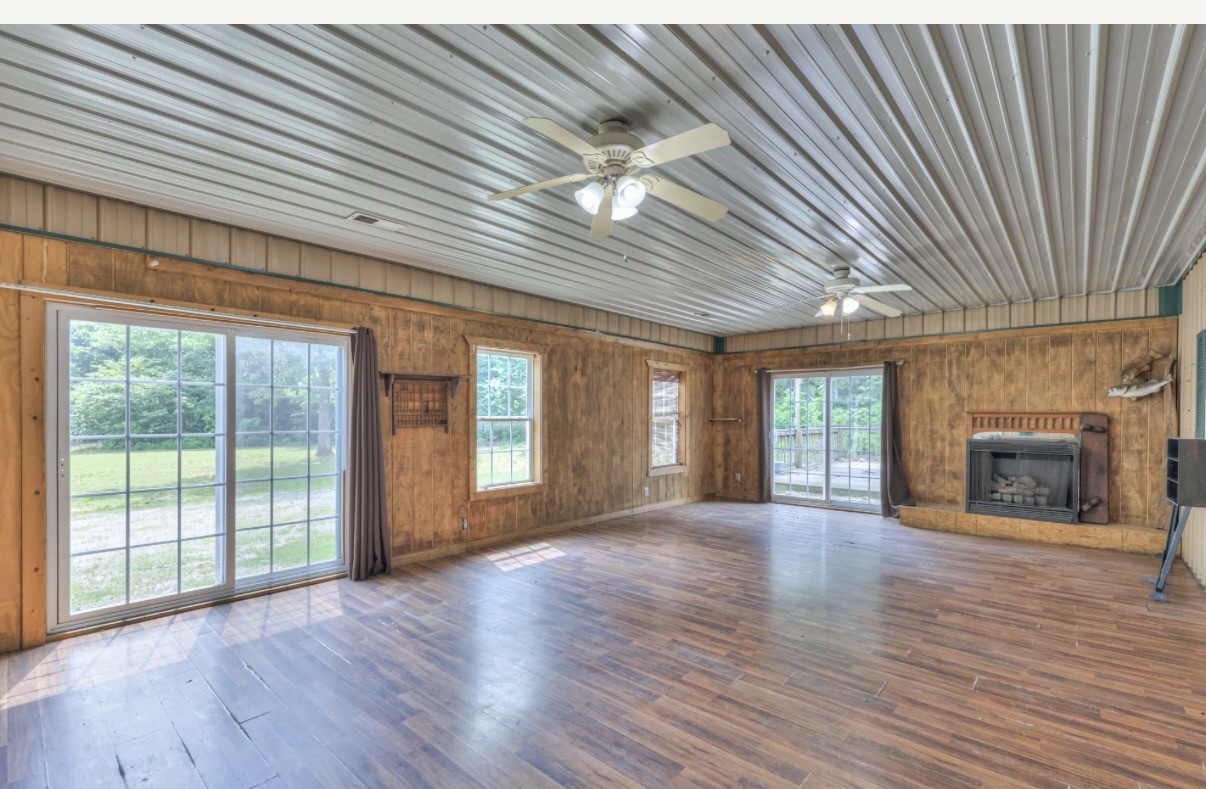 417 Haskins Chapel Road Lewisburg, TN 37091 - Photo 12 of 27 an empty room with wooden floor fireplace and windows