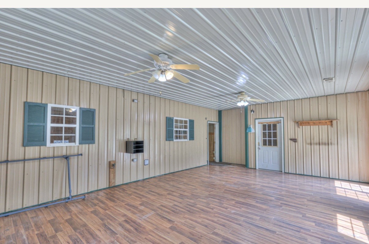 417 Haskins Chapel Road Lewisburg, TN 37091 - Photo 13 of 27 an empty room with wooden floor and windows
