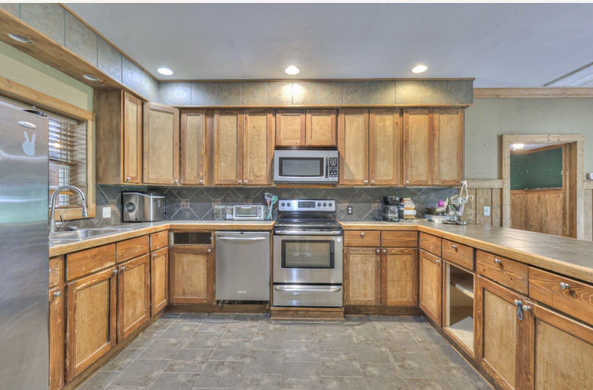 417 Haskins Chapel Road Lewisburg, TN 37091 - Photo 14 of 27 a kitchen with stainless steel appliances granite countertop a stove and a sink