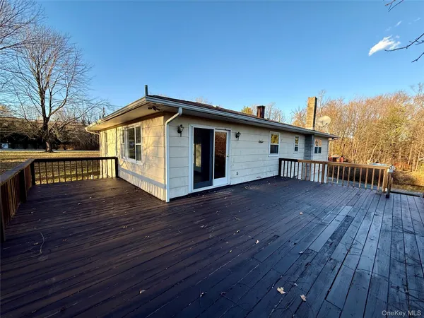 a view of a roof deck with wooden floor and fence