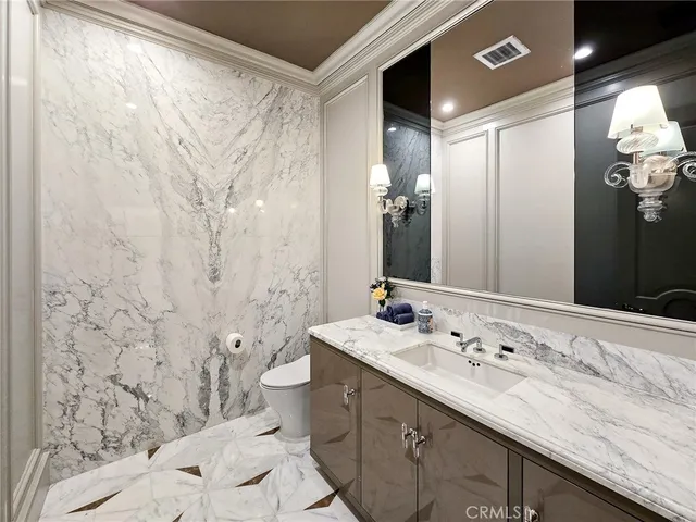a bathroom with a double vanity sink toilet and shower
