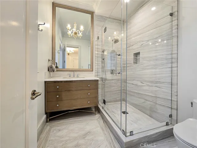 a bathroom with a granite countertop sink a mirror and a shower