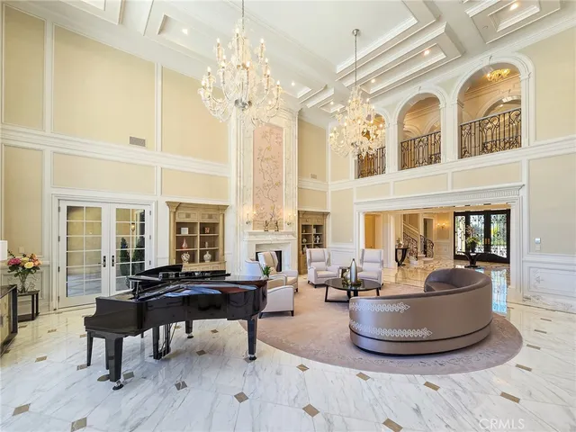 a living room with furniture and a chandelier