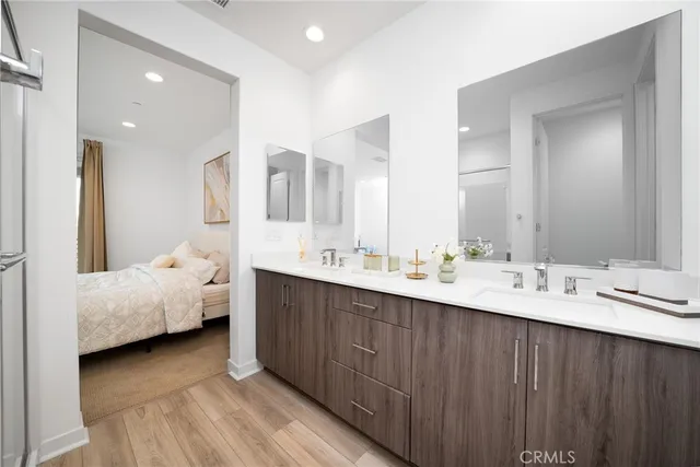 a en suite bathroom with double vanity sinks and a mirror
