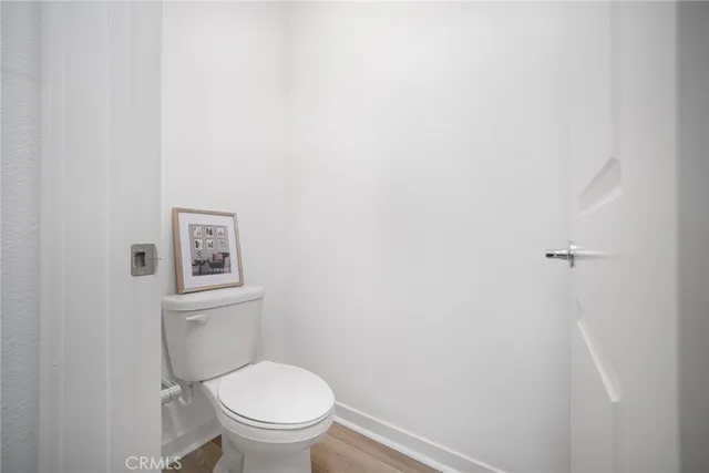 a white toilet sitting next to a shower
