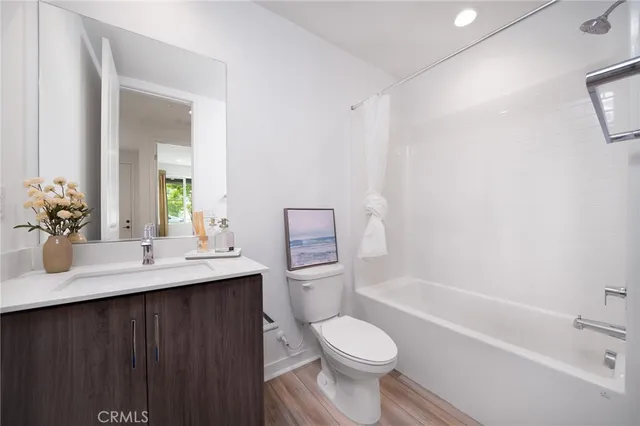 a bathroom with a sink toilet vanity and tub