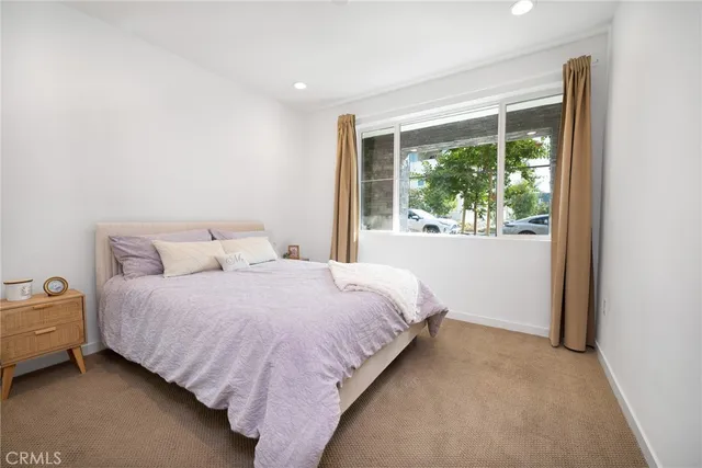 a bed sitting in a bedroom next to a window