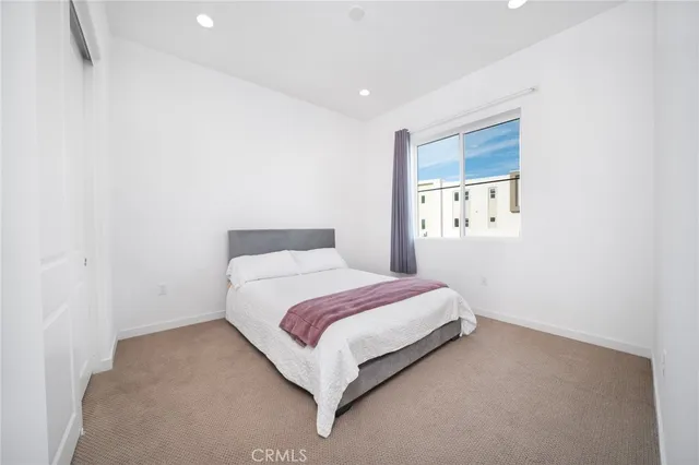 a bed room with a bed and a window