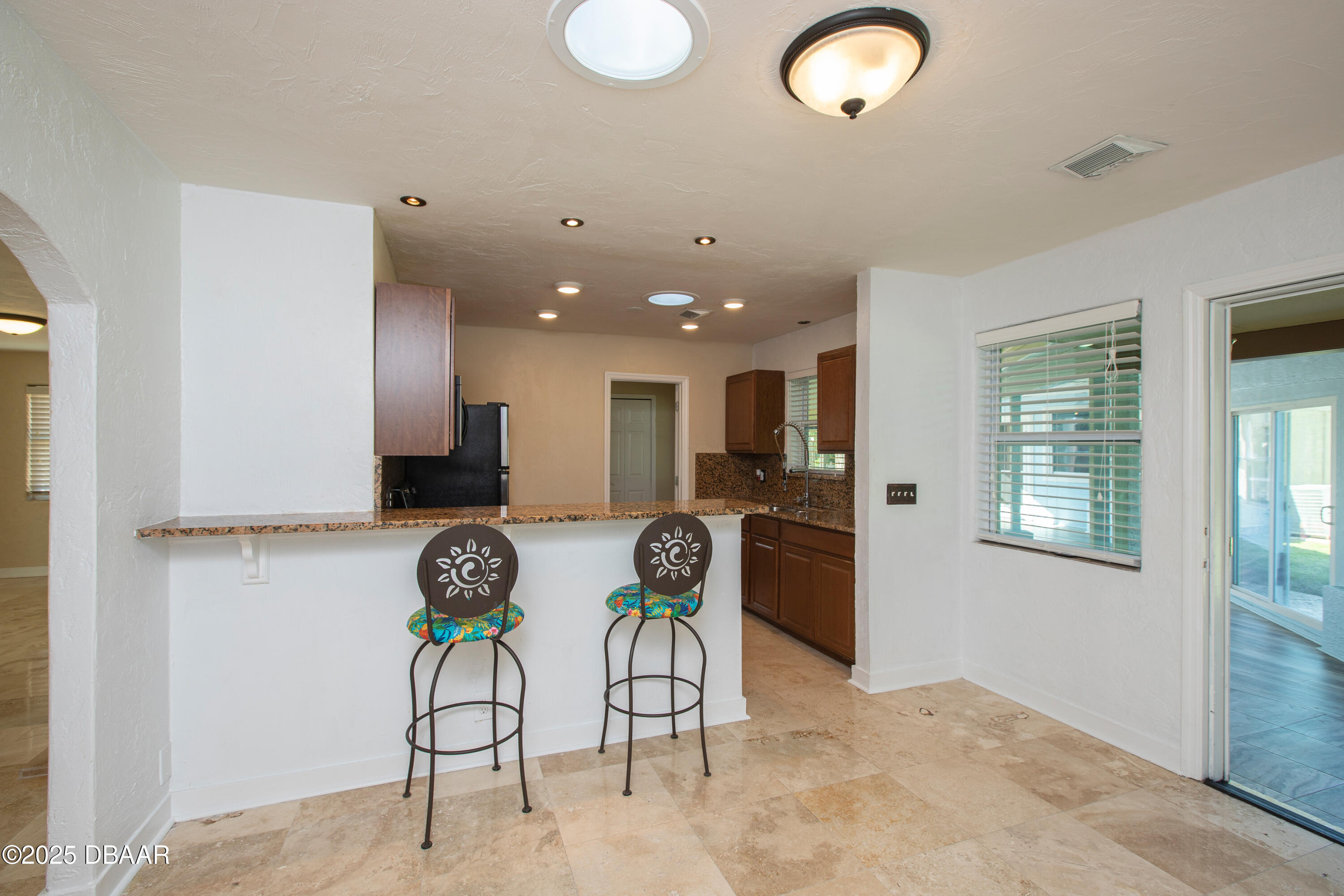 131 Minerva Road Daytona Beach, FL 32118 - Photo 17 of 21 a view of kitchen with stainless steel appliances kitchen island granite countertop a refrigerator and a stove top oven