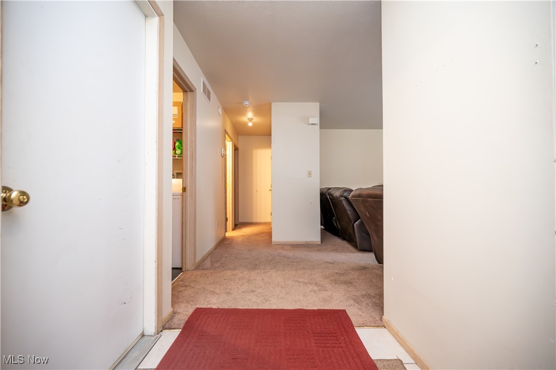 5546 Shaffer Road Northwest, Unit A & B Warren, OH 44481 - Photo 31 of 47 Hallway with light colored carpet and baseboards