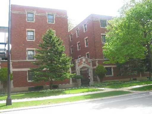 a brick building with a yard in front of it