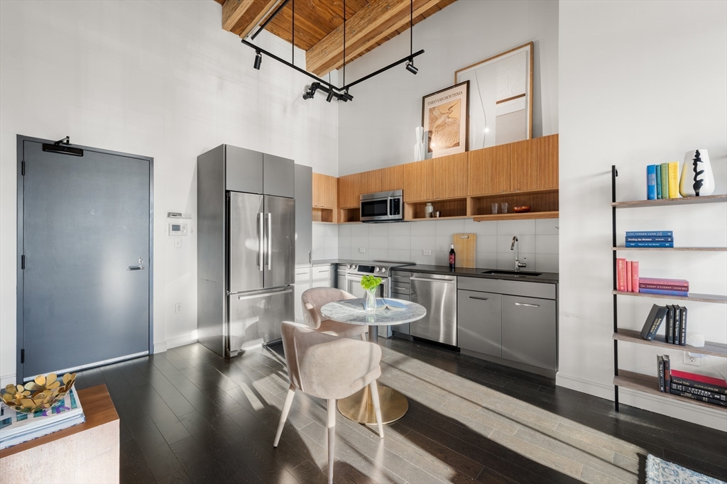 319 A Street, Unit 501 Boston, MA 02210 - Photo 3 of 24 a kitchen with stainless steel appliances a refrigerator and a stove top oven