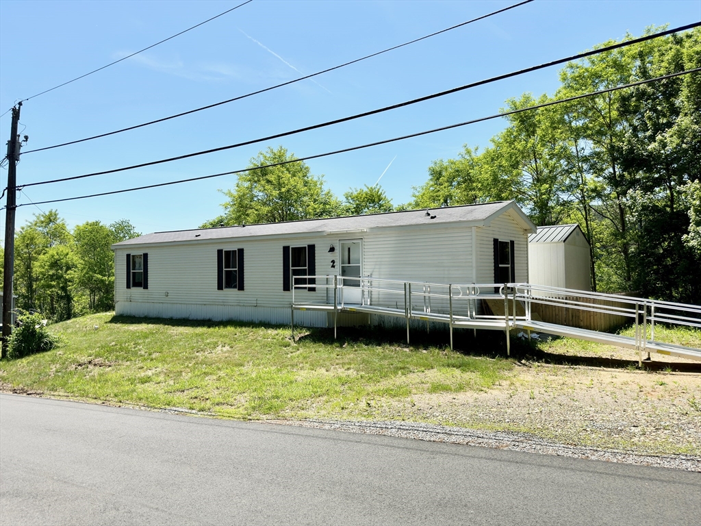 46 Madden Road, Unit 2 West Brookfield, MA 01585 - Photo 1 of 22 a view of a house with a backyard and a patio