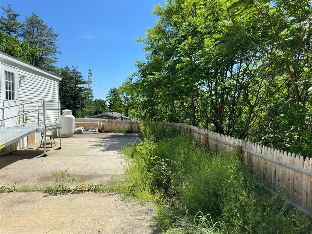46 Madden Road, Unit 2 West Brookfield, MA 01585 - Photo 18 of 22 a backyard of a house with yard and trampoline