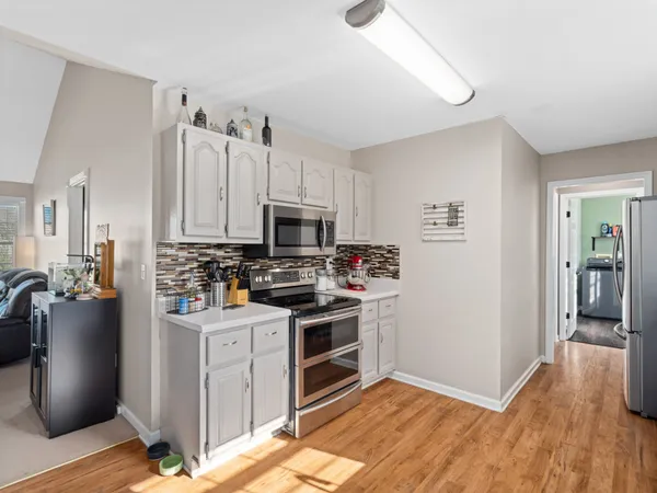 a kitchen with a sink cabinets and stainless steel appliances