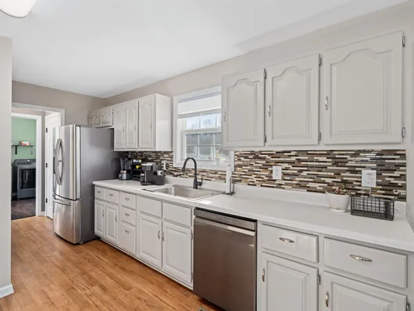 a kitchen with stainless steel appliances granite countertop a refrigerator sink and cabinets