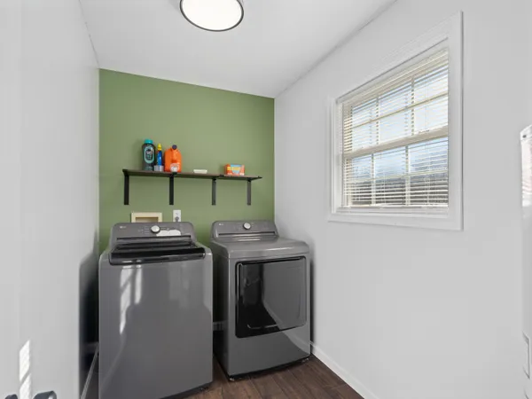 a view of kitchen island with sink cabinets and window