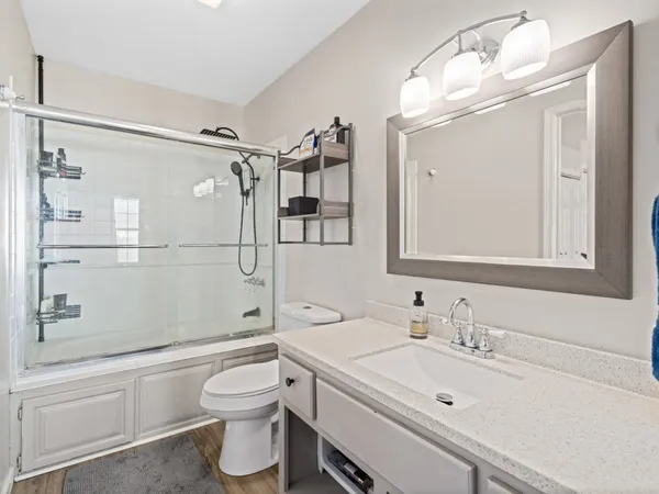 a bathroom with a sink a toilet and shower