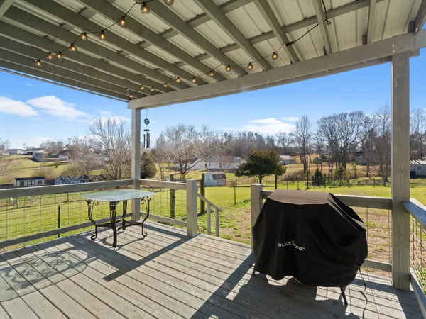 a view of a balcony with lake view and a floor to ceiling window next to a patio