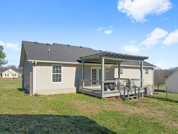 a view of a house with backyard porch and sitting area