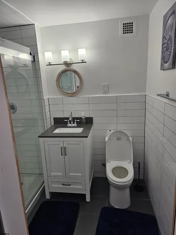 a bathroom with a toilet and a mirror
