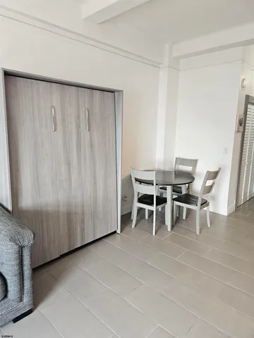a dining room with furniture and a rug