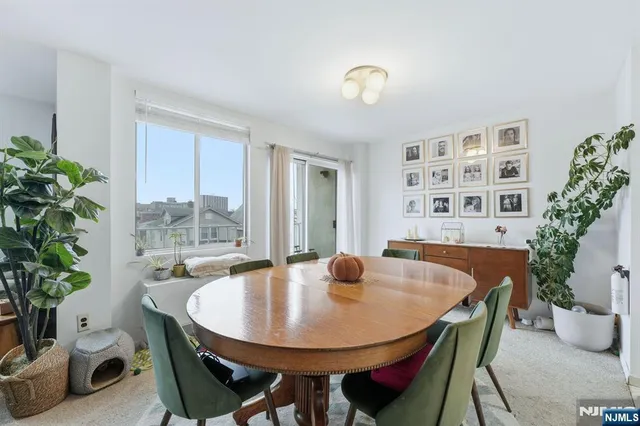 a dining room with furniture and window