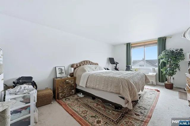 a bedroom with bed and a window