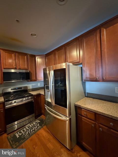 108 Leather Fern Way Frederick, MD 21702 - Photo 3 of 22 a kitchen with wooden cabinets and a stove top oven