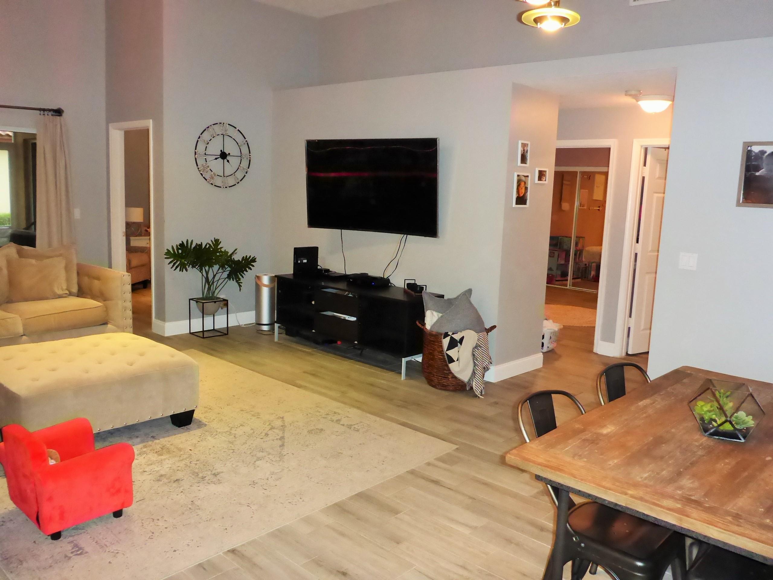 5009 Elpine Way Riviera Beach, FL 33418 - Photo 11 of 41 a living room with furniture and a flat screen tv