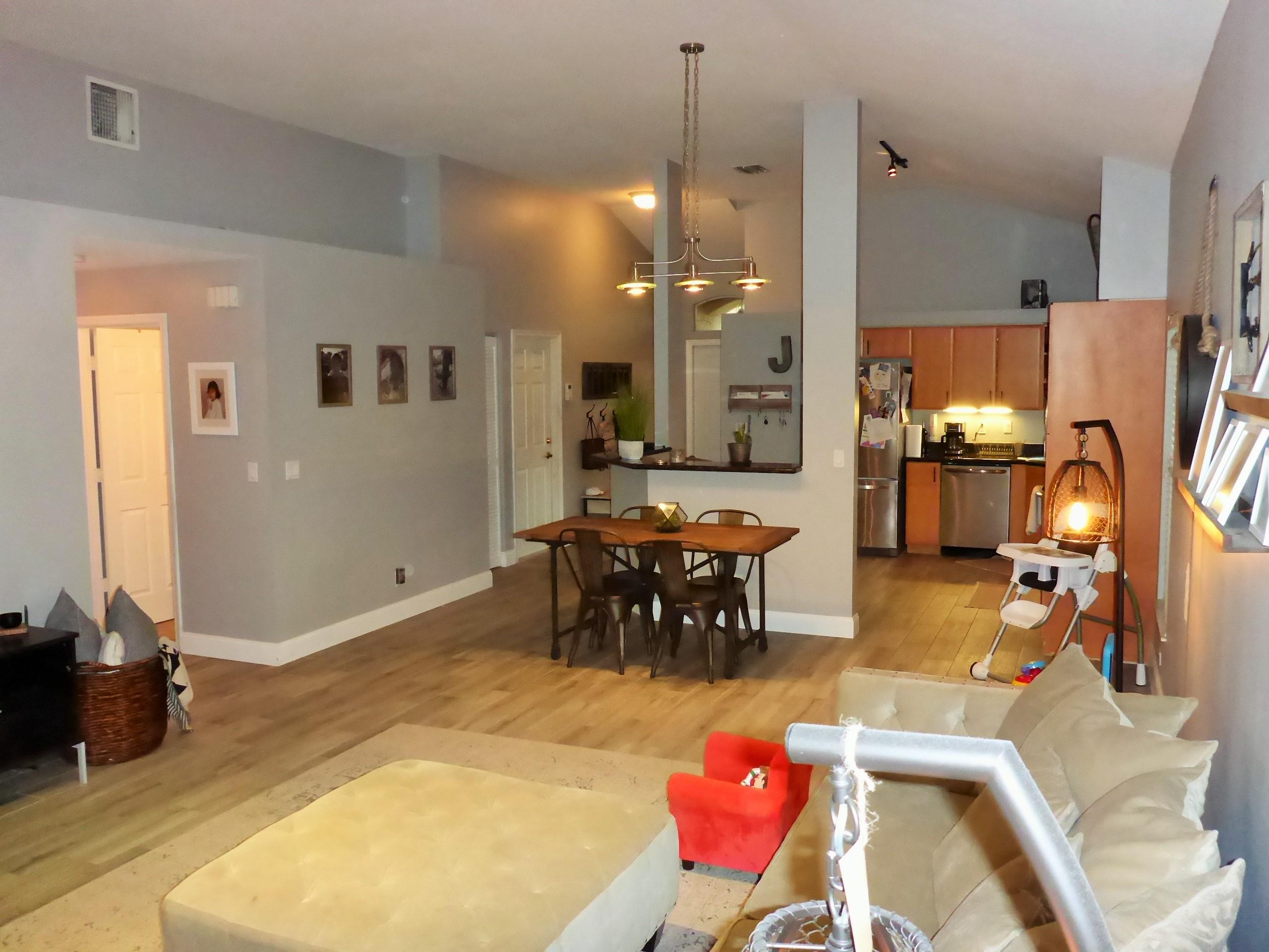 5009 Elpine Way Riviera Beach, FL 33418 - Photo 13 of 41 a living room with furniture a dining table and a chandelier