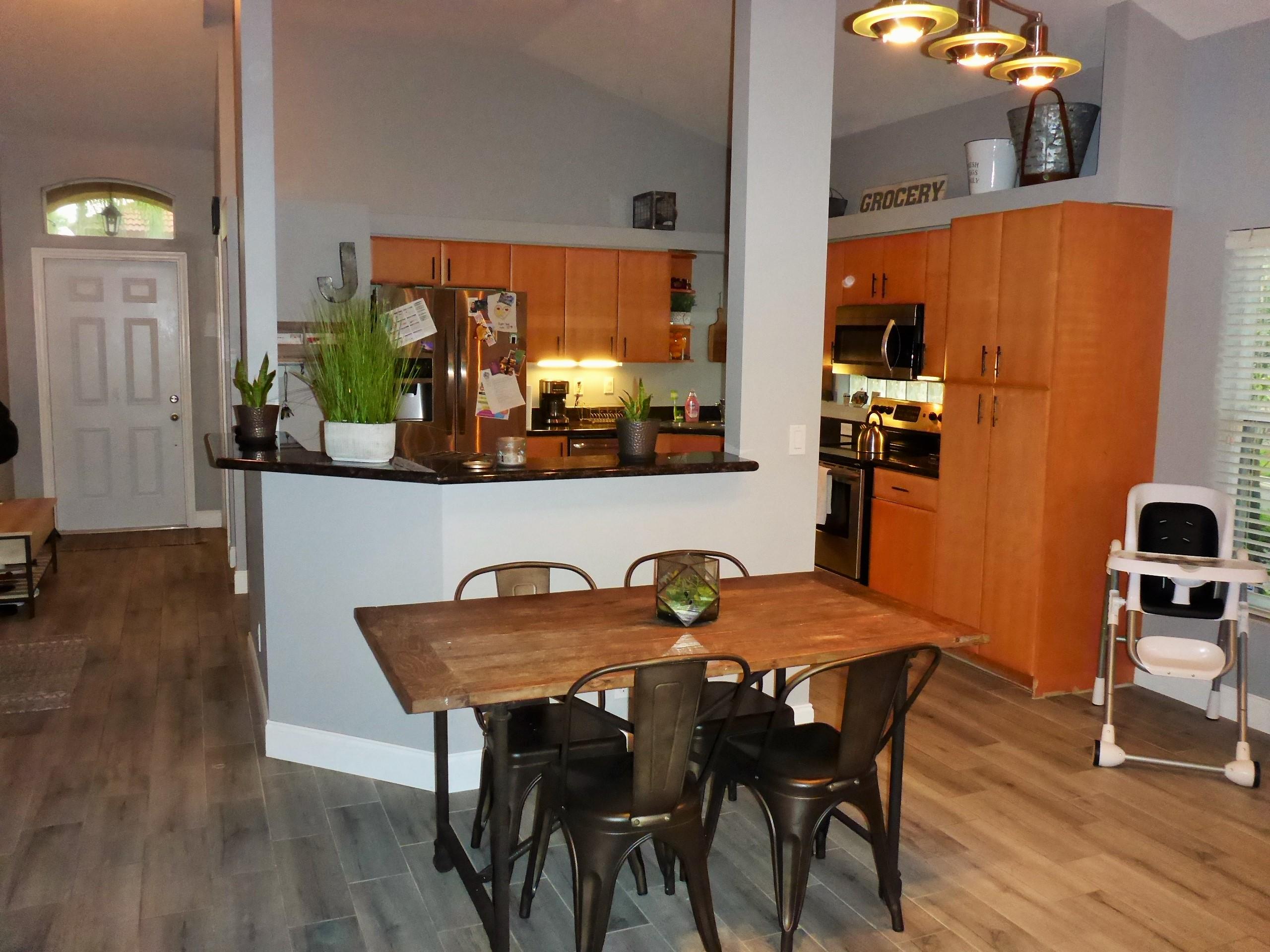 5009 Elpine Way Riviera Beach, FL 33418 - Photo 17 of 41 a view of a dining room with furniture and wooden floor