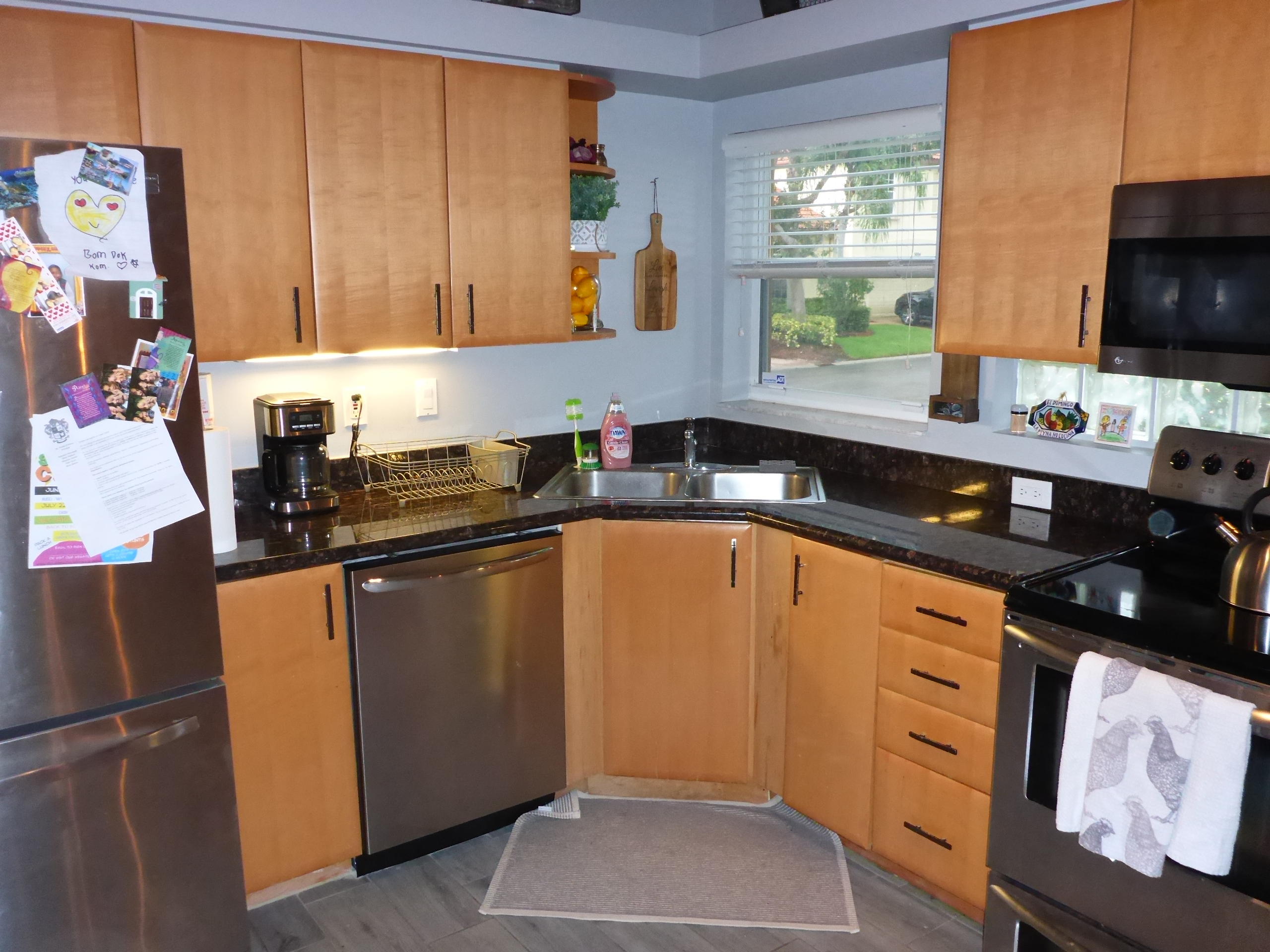5009 Elpine Way Riviera Beach, FL 33418 - Photo 21 of 41 a kitchen with stainless steel appliances granite countertop a sink stove and refrigerator