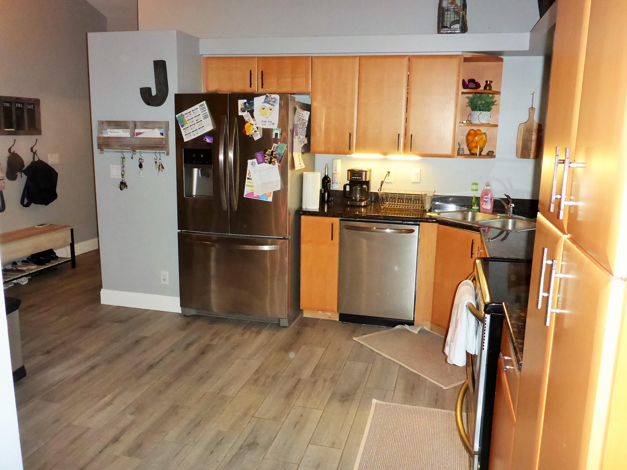 5009 Elpine Way Riviera Beach, FL 33418 - Photo 22 of 41 a kitchen with stainless steel appliances granite countertop a refrigerator and a sink